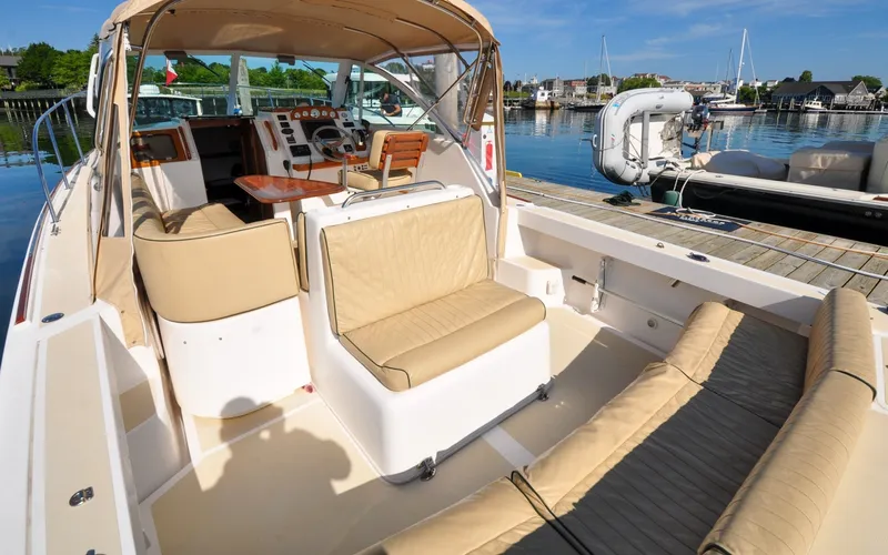 Slide: The Image of Hunt Surfhunter 29 - Judith Ann 2005 Hunt Yachts Surfhunter 29 with beige seating, docked in a sunny marina. - 6302499