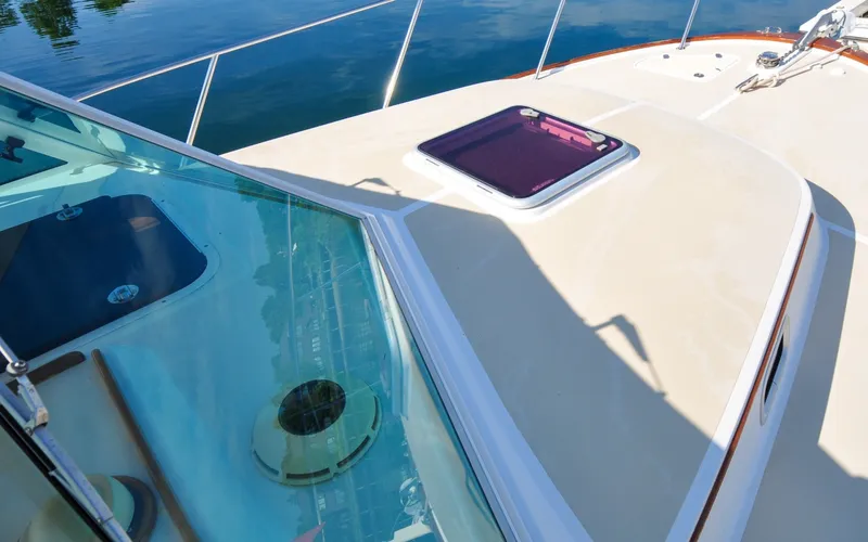 Slide: The Image of Hunt Surfhunter 29 - Judith Ann 2005 Hunt Yachts Surfhunter 29 deck with hatch and windshield, docked by the water. - 6302505