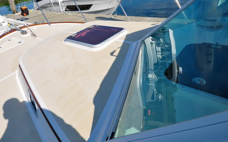 Slide: The Image of Hunt Surfhunter 29 - Judith Ann 2005 Hunt Yachts Surfhunter 29 deck with hatch and windshield, docked by the water. - 6302506