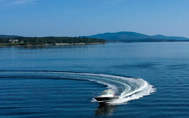Slide: The Image of Hunt Surfhunter 29 - Judith Ann 2005 Hunt Yachts Surfhunter 29 cruising on a serene lake with distant hills. - 6302490