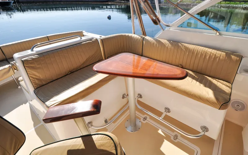Slide: The Image of Hunt Surfhunter 29 - Judith Ann 2005 Hunt Yachts Surfhunter 29 interior with tan seating and wooden table. - 6302482