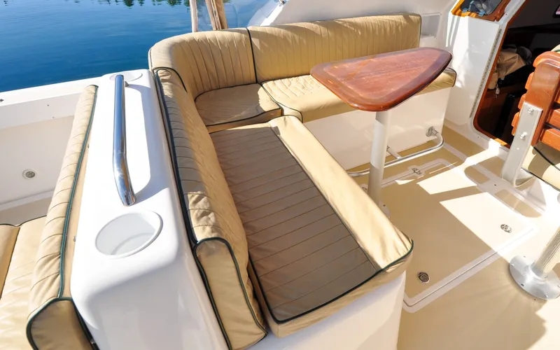 Slide: The Image of Hunt Surfhunter 29 - Judith Ann 2005 Hunt Yachts Surfhunter 29 interior with beige seating and wooden table. - 6302514