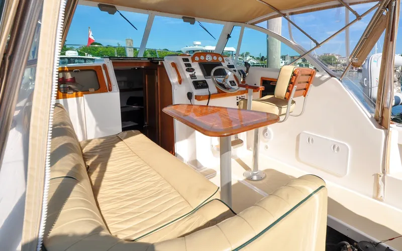 Slide: The Image of Hunt Surfhunter 29 - Judith Ann 2005 Hunt Yachts Surfhunter 29 interior with beige seating and wooden accents. - 6302518