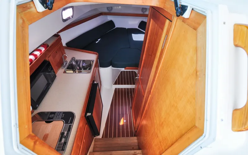 Slide: The Image of Hunt Surfhunter 29 - Judith Ann 2005 Hunt Yachts Surfhunter 29 cabin interior with kitchenette and wood finish. - 6302483
