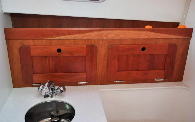 Slide: The Image of Hunt Surfhunter 29 - Judith Ann 2005 Hunt Yachts Surfhunter 29 interior with wooden cabinets and stainless steel sink. - 6302521
