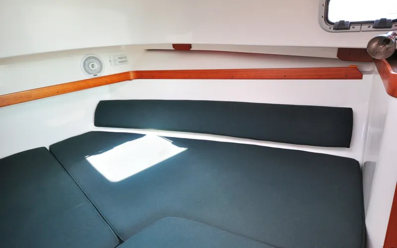 Slide: The Image of Hunt Surfhunter 29 - Judith Ann 2005 Hunt Yachts Surfhunter 29 cabin interior with cushioned seating and wooden accents. - 6302524