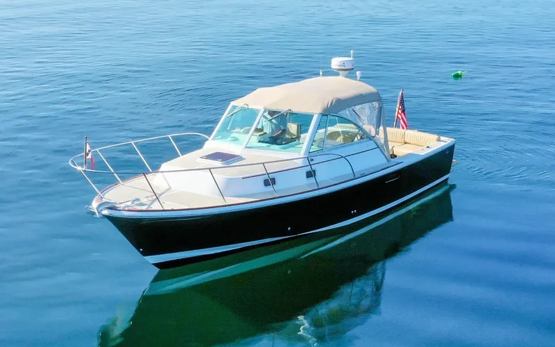 Slide: The Image of Hunt Surfhunter 29 - Judith Ann 2005 Hunt Yachts Surfhunter 29 boat on calm blue water, featuring a sleek design. - 6302470