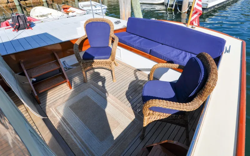 Slide: The Image of 1958 Bunker and Ellis 42 | Aleria 1958 Bunker and Ellis 42 boat deck with wicker chairs and blue cushions. - 6307415