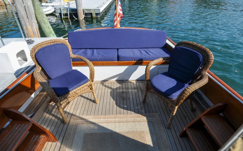 Slide: The Image of 1958 Bunker and Ellis 42 | Aleria Vintage 1958 Bunker and Ellis 42 boat deck with wicker chairs and blue cushions. - 6307411