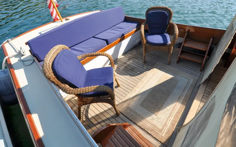 Slide: The Image of 1958 Bunker and Ellis 42 | Aleria 1958 Bunker and Ellis 42 boat deck with wicker chairs and blue cushions. - 6307416