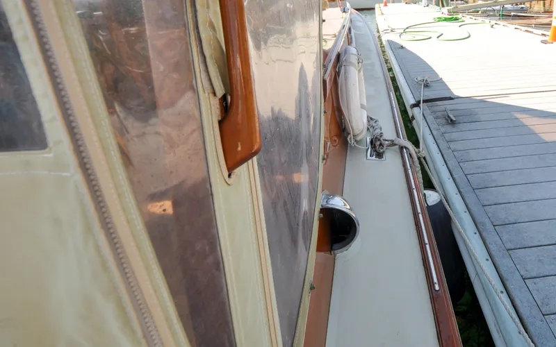 Slide: The Image of 1958 Bunker and Ellis 42 | Aleria 1958 Bunker and Ellis 42 boat docked, showcasing side view with wooden details. - 6307466