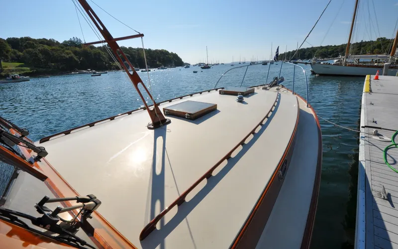 Slide: The Image of 1958 Bunker and Ellis 42 | Aleria 1958 Bunker and Ellis 42 boat docked on a sunny day, surrounded by calm waters. - 6307469