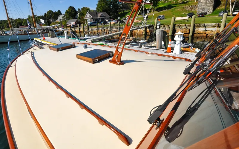 Slide: The Image of 1958 Bunker and Ellis 42 | Aleria 1958 Bunker and Ellis 42 yacht docked at a scenic marina with clear skies. - 6307431