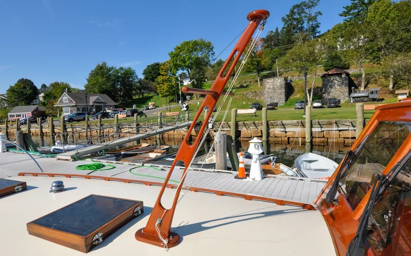 Slide: The Image of 1958 Bunker and Ellis 42 | Aleria 1958 Bunker and Ellis 42 boat docked at a scenic marina with lush greenery. - 6307412