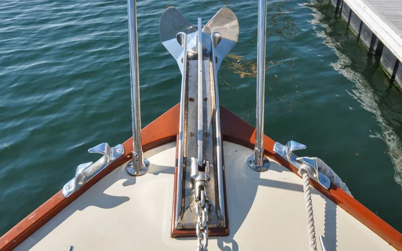 Slide: The Image of 1958 Bunker and Ellis 42 | Aleria Bow of a 1958 Bunker and Ellis 42 boat with anchor and calm water. - 6307474