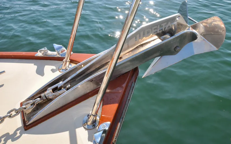 Slide: The Image of 1958 Bunker and Ellis 42 | Aleria Anchor detail on a 1958 Bunker and Ellis 42 boat, floating on calm water. - 6307475