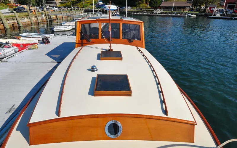 Slide: The Image of 1958 Bunker and Ellis 42 | Aleria 1958 Bunker and Ellis 42 boat docked at a marina, showcasing classic wooden design. - 6307433