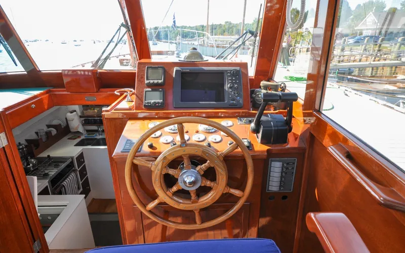Slide: The Image of 1958 Bunker and Ellis 42 | Aleria 1958 Bunker and Ellis 42 boat helm with wooden wheel and navigation equipment. - 6307437