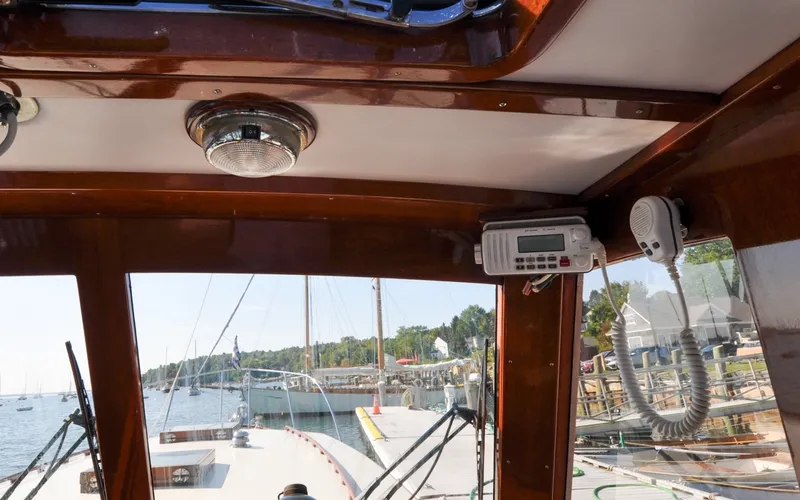 Slide: The Image of 1958 Bunker and Ellis 42 | Aleria Interior view of a 1958 Bunker and Ellis 42 boat, showcasing wooden details and marine equipment. - 6307482