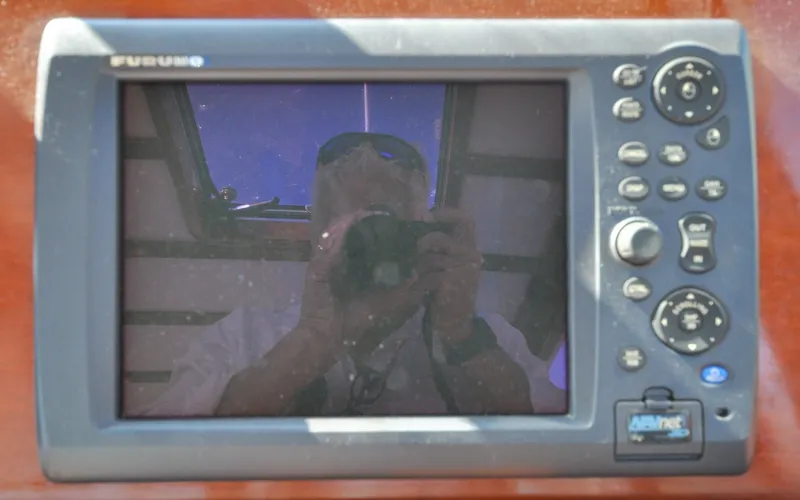 Slide: The Image of 1958 Bunker and Ellis 42 | Aleria Reflection on a Furuno marine display screen aboard a 1958 Bunker and Ellis 42 boat. - 6307485