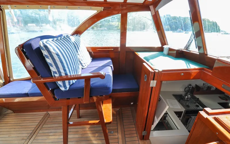Slide: The Image of 1958 Bunker and Ellis 42 | Aleria Interior of a 1958 Bunker and Ellis 42 boat with blue seating and wooden finishes. - 6307494