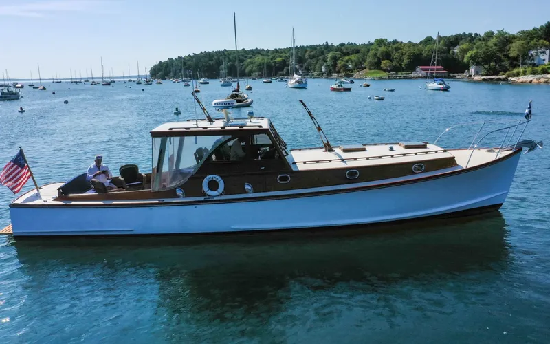 Slide: The Image of 1958 Bunker and Ellis 42 | Aleria 1958 Bunker and Ellis 42 boat cruising in a scenic harbor with moored sailboats. - 6307426