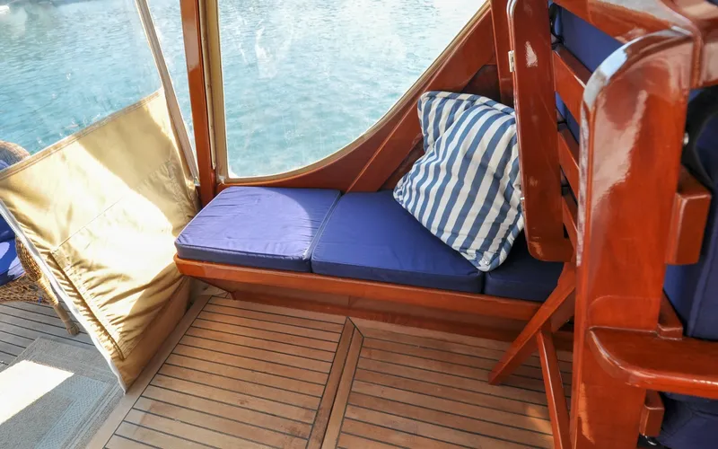 Slide: The Image of 1958 Bunker and Ellis 42 | Aleria Interior of 1958 Bunker and Ellis 42 boat with blue cushions and striped pillow. - 6307495