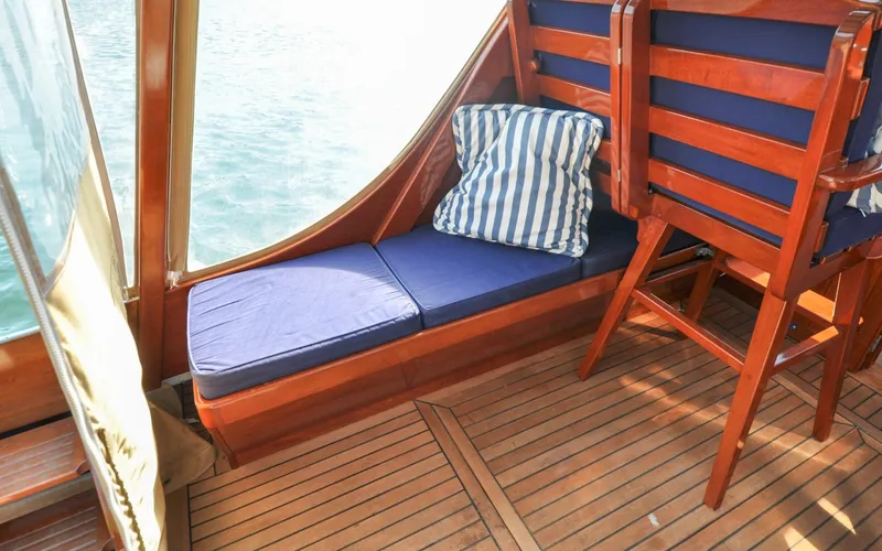Slide: The Image of 1958 Bunker and Ellis 42 | Aleria Interior of 1958 Bunker and Ellis 42 boat with blue cushions and striped pillow. - 6307440