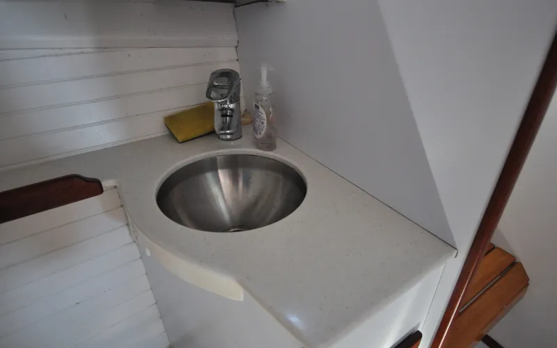 Slide: The Image of 1958 Bunker and Ellis 42 | Aleria Stainless steel sink in 1958 Bunker and Ellis 42 boat interior. - 6307499