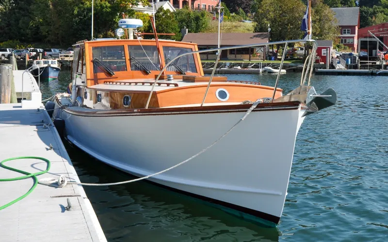 Slide: The Image of 1958 Bunker and Ellis 42 | Aleria Classic 1958 Bunker and Ellis 42 boat docked in a scenic marina setting. - 6307428