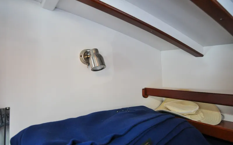 Slide: The Image of 1958 Bunker and Ellis 42 | Aleria Interior of 1958 Bunker and Ellis 42 boat with spotlight and wooden shelves. - 6307506