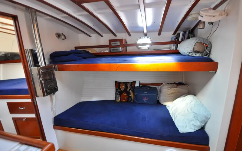 Slide: The Image of 1958 Bunker and Ellis 42 | Aleria Cozy cabin interior of 1958 Bunker and Ellis 42 boat with blue bunk beds. - 6307501