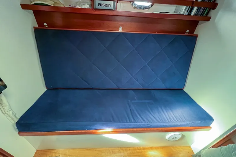 Slide: The Image of 1958 Bunker and Ellis 42 | Aleria 1958 Bunker and Ellis 42 interior with blue cushioned seating and wooden shelves. - 6307446