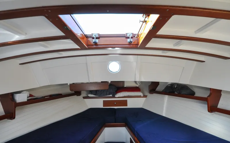 Slide: The Image of 1958 Bunker and Ellis 42 | Aleria Interior of a 1958 Bunker and Ellis 42 boat with wooden accents and cozy sleeping area. - 6307514