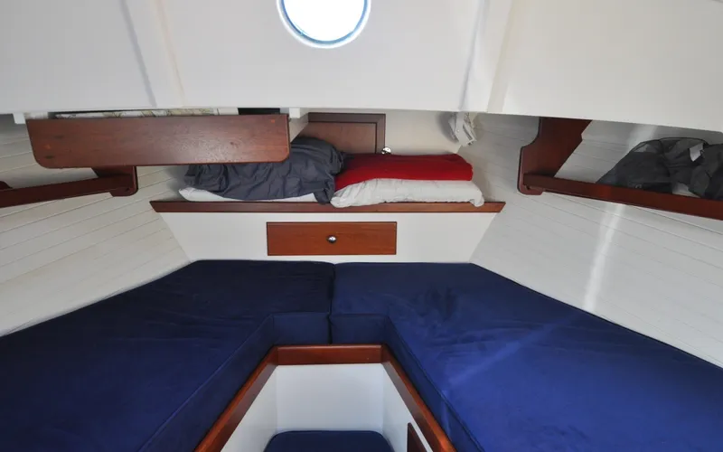 Slide: The Image of 1958 Bunker and Ellis 42 | Aleria Cozy cabin interior of a 1958 Bunker and Ellis 42 boat with blue cushions. - 6307512