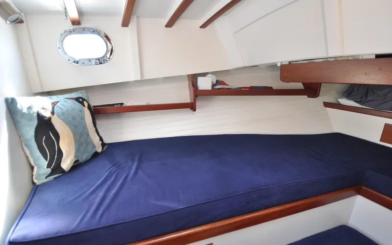 Slide: The Image of 1958 Bunker and Ellis 42 | Aleria Cozy cabin interior of 1958 Bunker and Ellis 42 with penguin-themed pillow. - 6307513