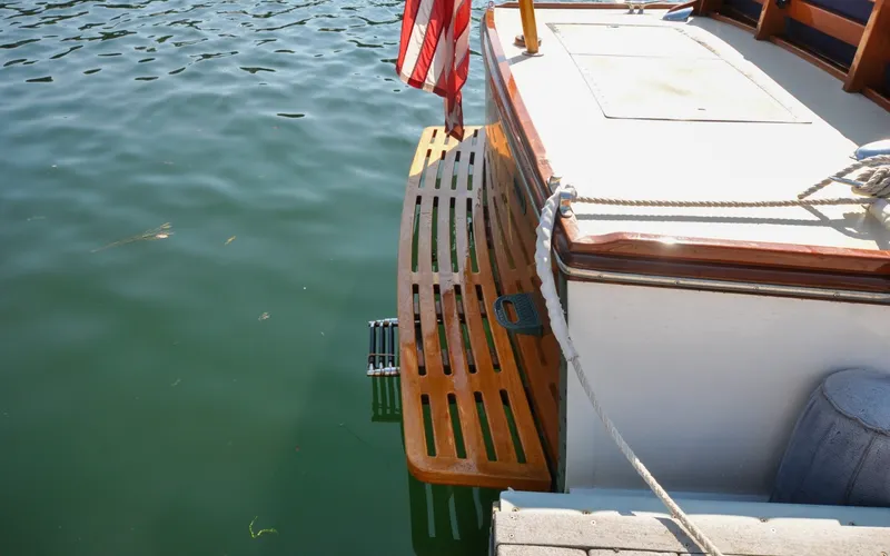 Slide: The Image of 1958 Bunker and Ellis 42 | Aleria Vintage 1958 Bunker and Ellis 42 boat with wooden swim platform and American flag. - 6307429