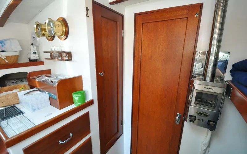 Slide: The Image of 1958 Bunker and Ellis 42 | Aleria Interior of a 1958 Bunker and Ellis 42 boat with wooden cabinetry and nautical decor. - 6307516