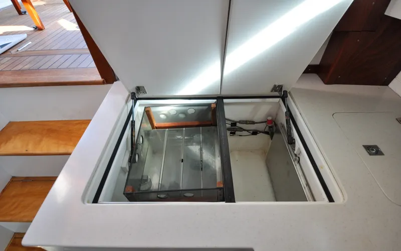 Slide: The Image of 1958 Bunker and Ellis 42 | Aleria Open storage compartment on a 1958 Bunker and Ellis 42 boat interior. - 6307527
