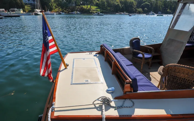 Slide: The Image of 1958 Bunker and Ellis 42 | Aleria 1958 Bunker and Ellis 42 boat with American flag on calm water. - 6307410