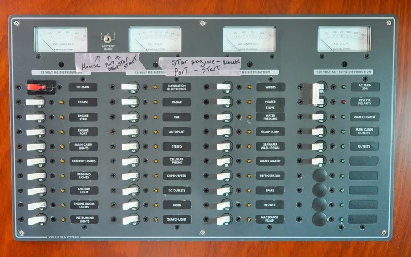 Slide: The Image of 1958 Bunker and Ellis 42 | Aleria Electrical control panel of a 1958 Bunker and Ellis 42 boat, featuring various switches and meters. - 6307528