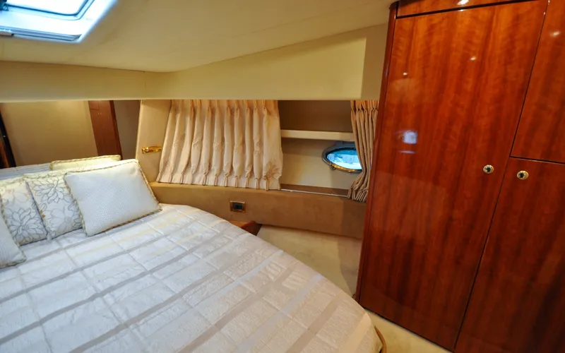Slide: The Image of 1996 Azimut 54 | Calmati Luxurious cabin interior of 1996 Azimut Cinquantaquattro yacht with elegant wood finishes. - 6308946