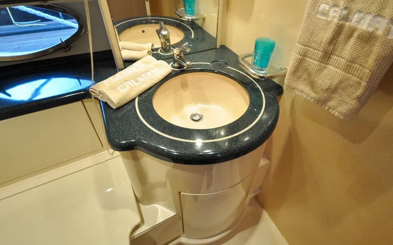 Slide: The Image of 1996 Azimut 54 | Calmati Luxurious bathroom sink in 1996 Azimut Cinquantaquattro yacht, featuring elegant design. - 6308958