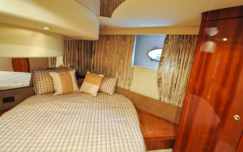 Slide: The Image of 1996 Azimut 54 | Calmati Luxurious bedroom interior of 1996 Azimut Cinquantaquattro yacht with elegant bedding and wood accents. - 6308965