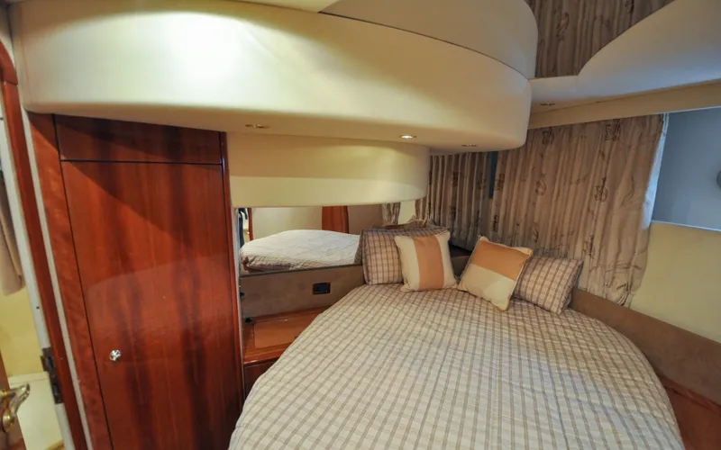 Slide: The Image of 1996 Azimut 54 | Calmati Luxurious bedroom interior of 1996 Azimut Cinquantaquattro yacht with elegant bedding and wood accents. - 6308964