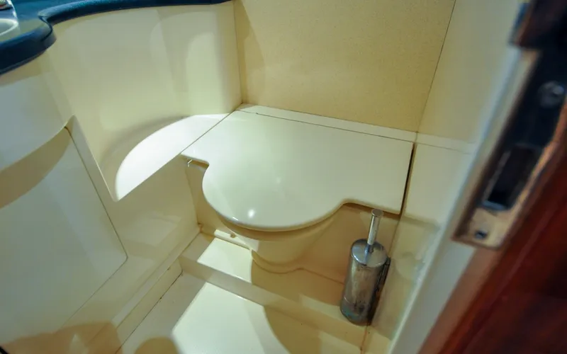Slide: The Image of 1996 Azimut 54 | Calmati 1996 Azimut Cinquantaquattro yacht bathroom with compact toilet and brush holder. - 6308966