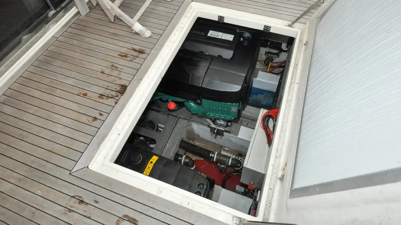 Slide: The Image of 1996 Azimut 54 | Calmati Engine compartment of a 1996 Azimut 54 yacht, showcasing mechanical components and wiring. - 6309004