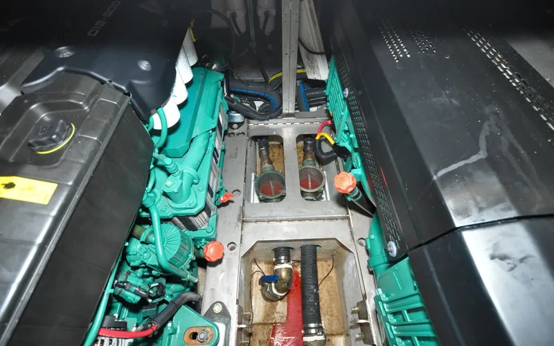 Slide: The Image of 1996 Azimut 54 | Calmati Engine room of a 1996 Azimut 54 yacht, showcasing dual engines and mechanical components. - 6309013
