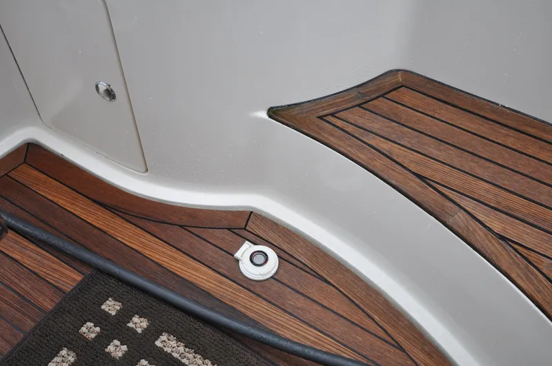 Slide: The Image of 1996 Azimut 54 | Calmati Teak deck detail of 1996 Azimut Cinquantaquattro yacht with a white fitting. - 6308577