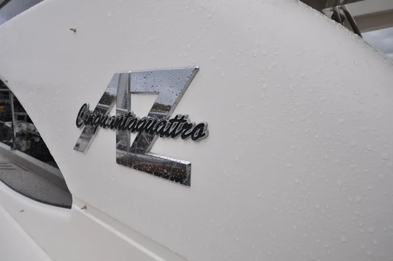 Slide: The Image of 1996 Azimut 54 | Calmati Chrome Azimut Cinquantaquattro logo on a wet surface, 1996 model. - 6308583